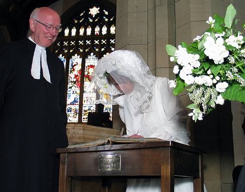 Sutcliffe Sowden watches Charlotte sign the register